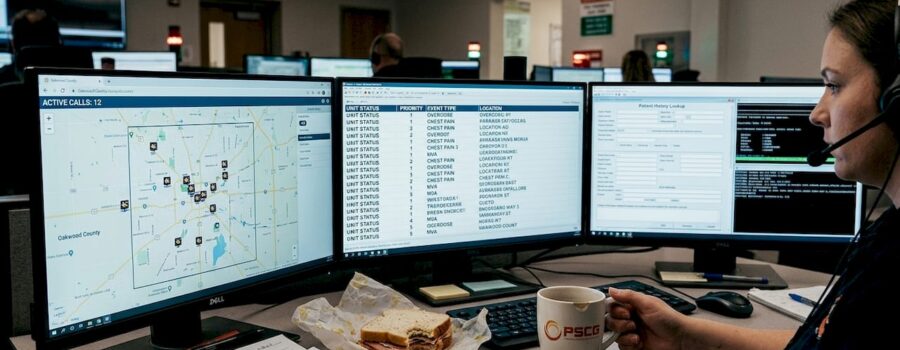 EMS dispatcher at busy workstation during emergency call