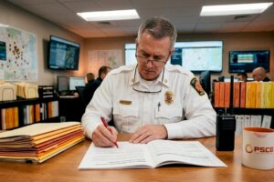 Fire chief assessing report at table