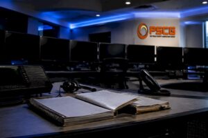 Empty emergency dispatch center with PSCG logo
