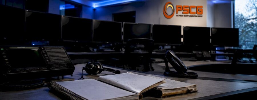 Empty emergency dispatch center with PSCG logo