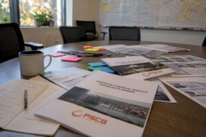 EMS disaster plan documents with PSCG Logo on conference table
