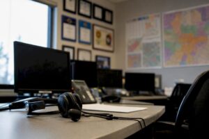 EMS operations desk with headset and PSCG logo