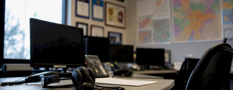 EMS operations desk with headset and PSCG logo