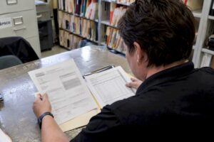 EMS billing specialist reviewing denied claim paperwork