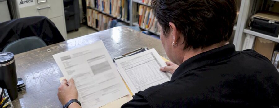 EMS billing specialist reviewing denied claim paperwork